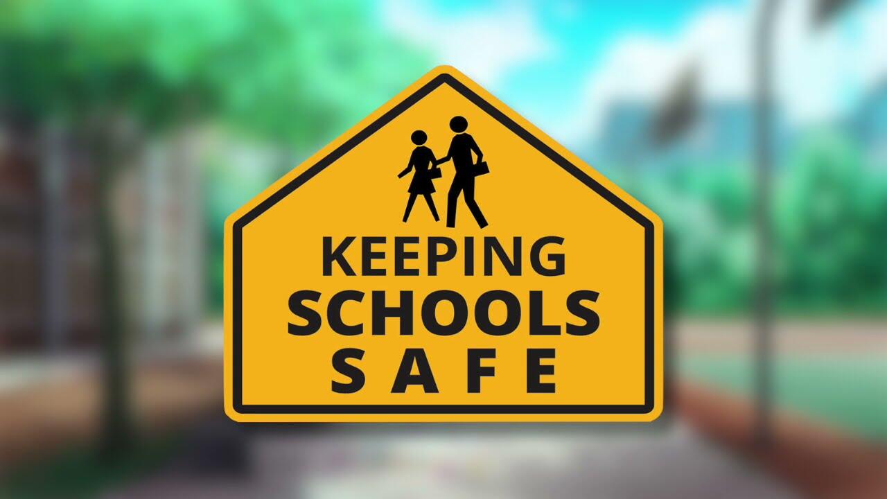 Yellow street sign with a student and parent walking that reads Keeping Schools Safe