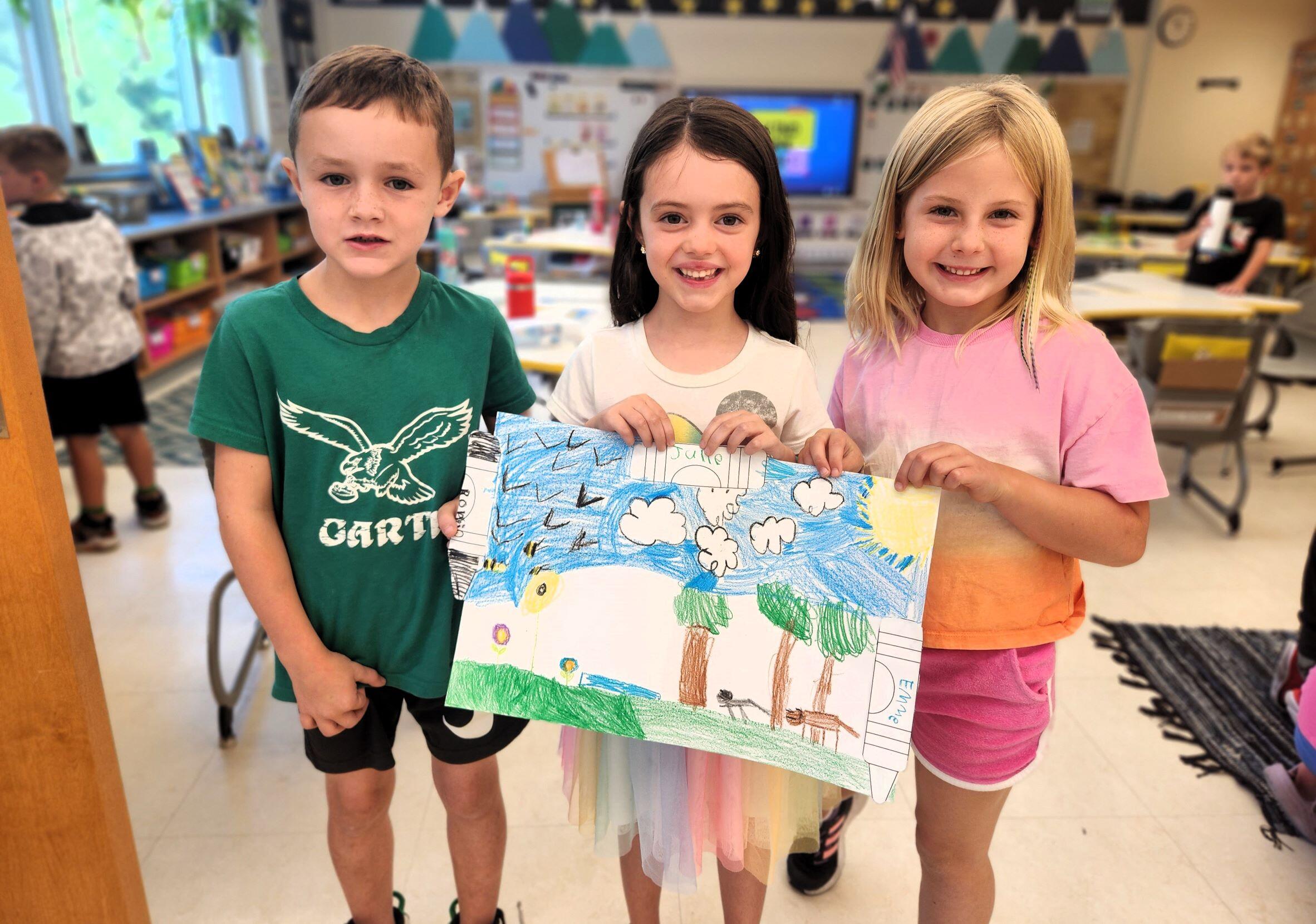 Enf- Three students show off their picture