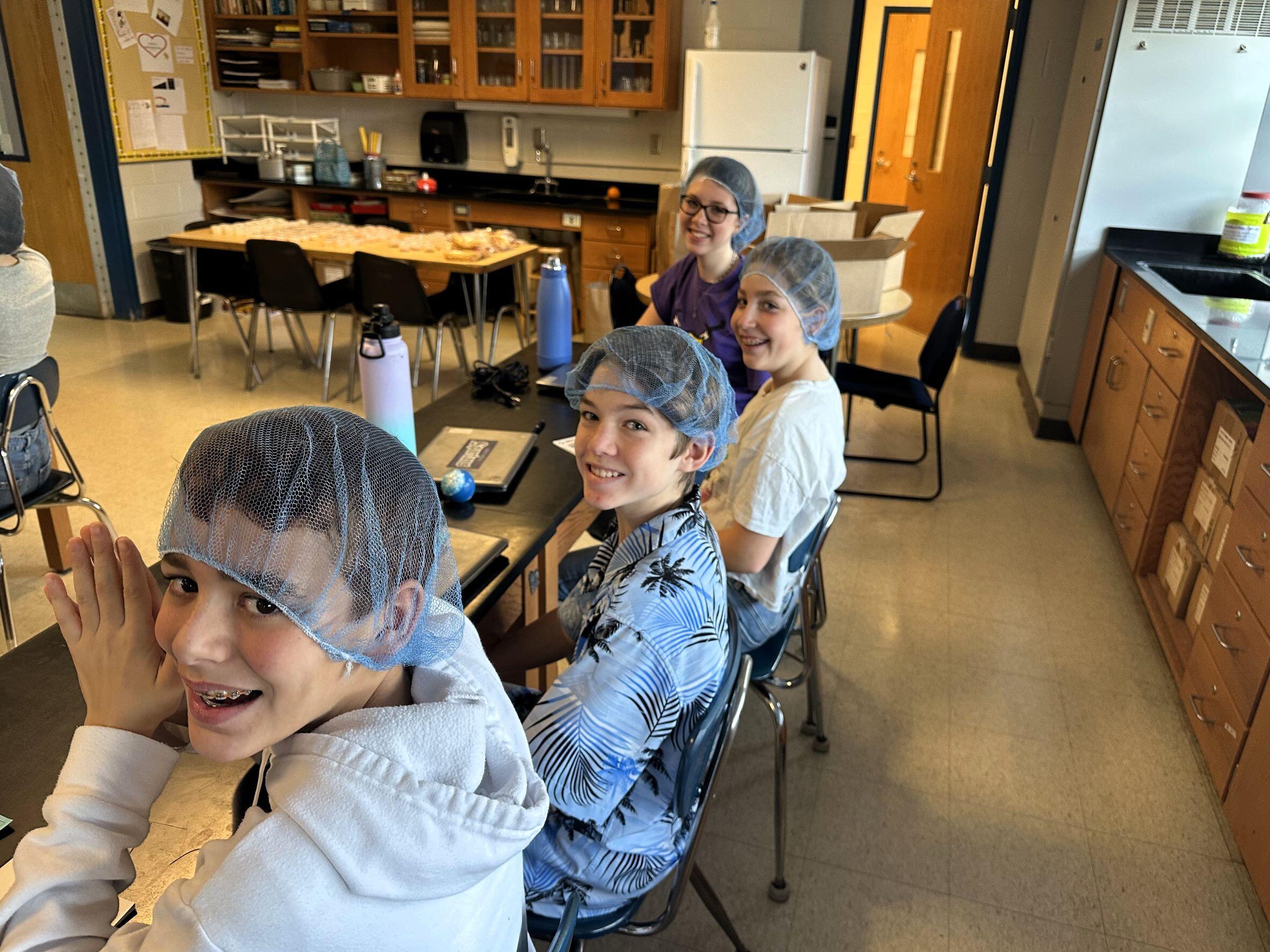 Students wearing hair nets in Science class